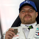 A photo of Valtteri Bottas drinking coffee in the F1 garage.